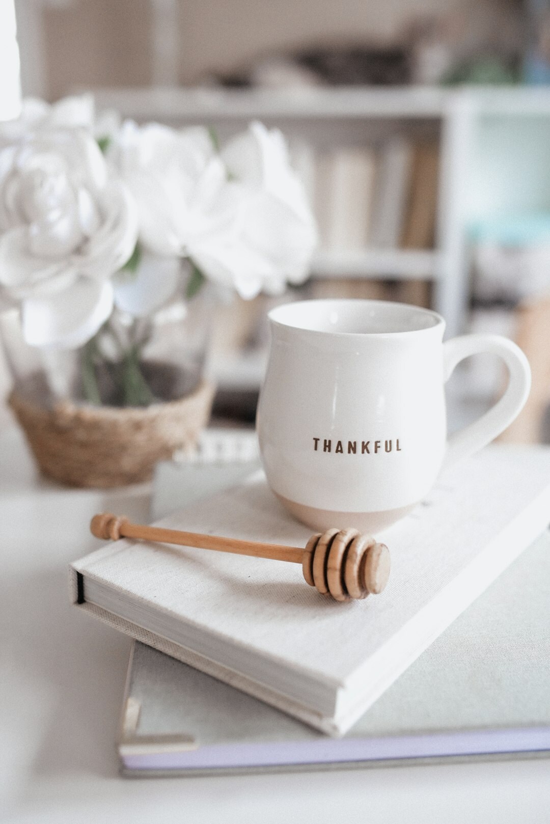 Overhead view of a notebook, pen and cup of coffee on a wooden desk